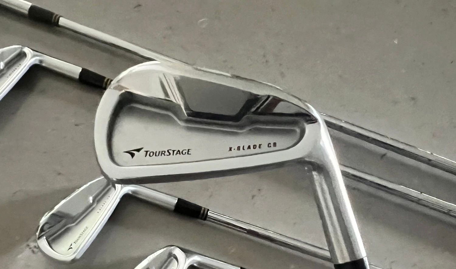 Close-up of a silver Tour Edge E723 golf iron head in a set.