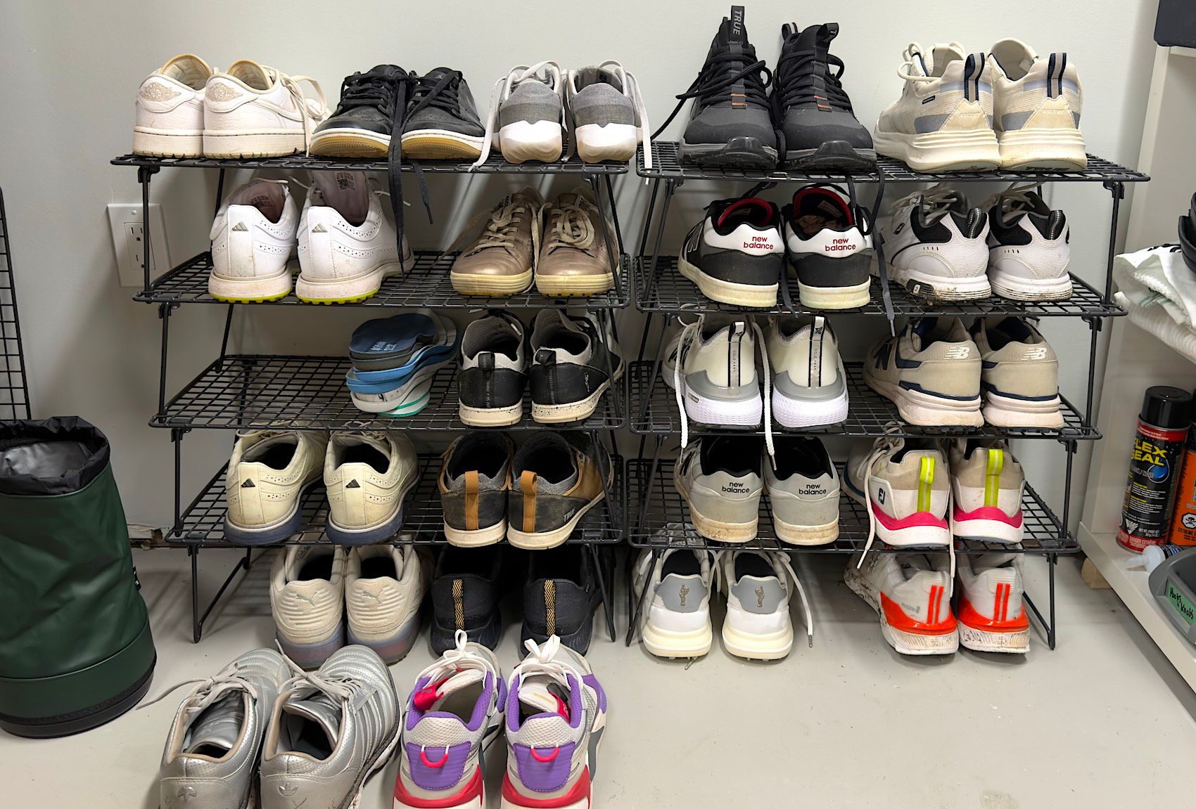 Multi-tiered shoe rack filled with various sneakers and casual shoes in different styles.