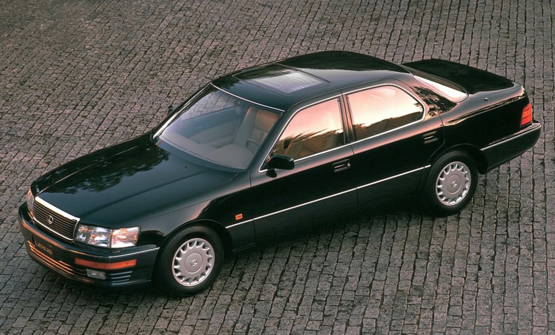 Dark luxury Lexus LS 400 sedan parked on pavement, viewed from an elevated angle.