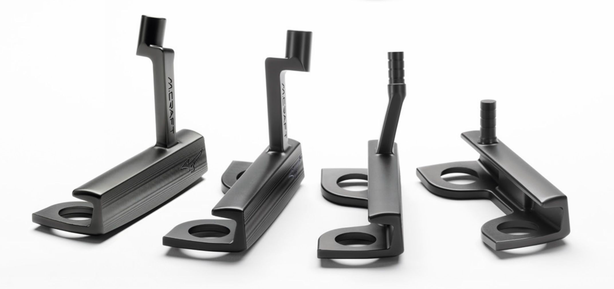 Four dark industrial L-shaped components with vertical posts on a white background.